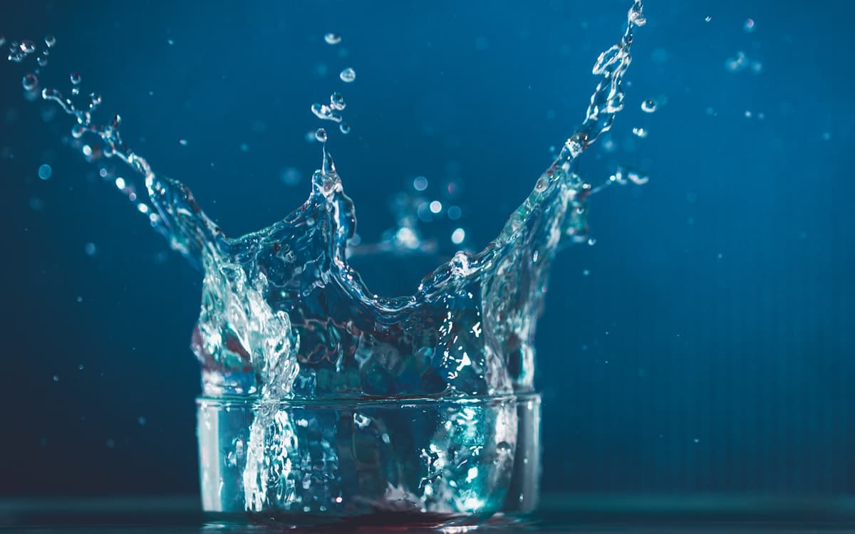 Water splashing up from a glass, representing rehydration and IV hydration therapy