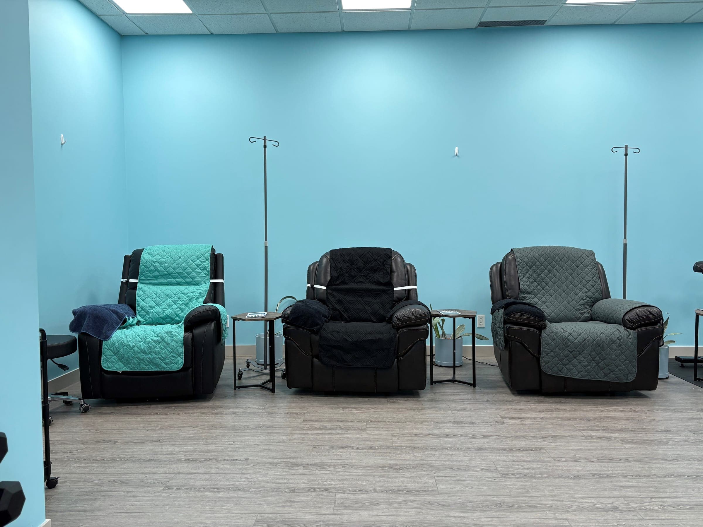 IV therapy room at Solis Medical Clinic in Edmonton with three recliner chairs and IV poles